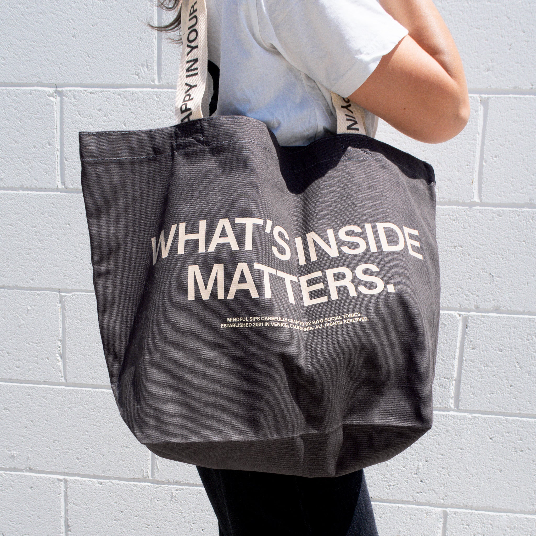 hiyo-rewards-merch-tote-charcoal-whatsinside-front-lifestyle-low.jpg